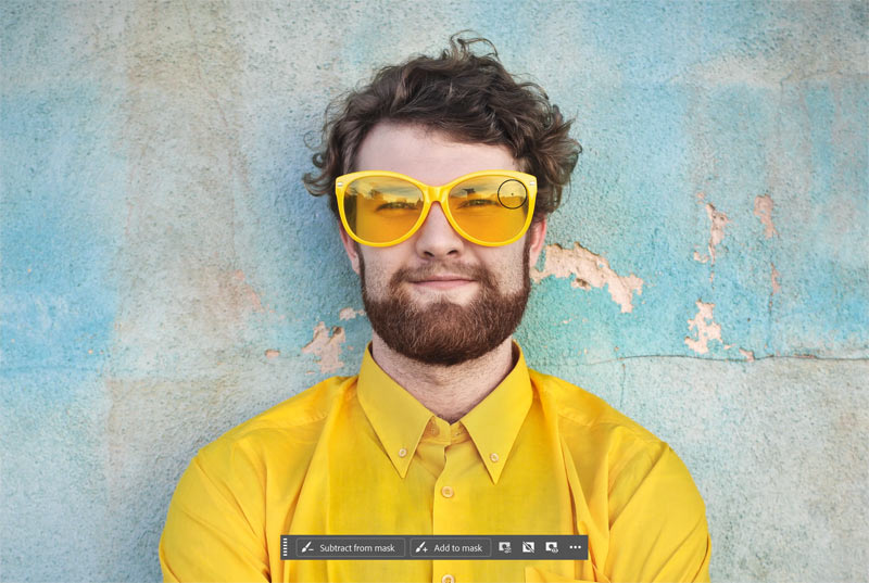 Painting on the layer mask with white to reveal the sunglasses.