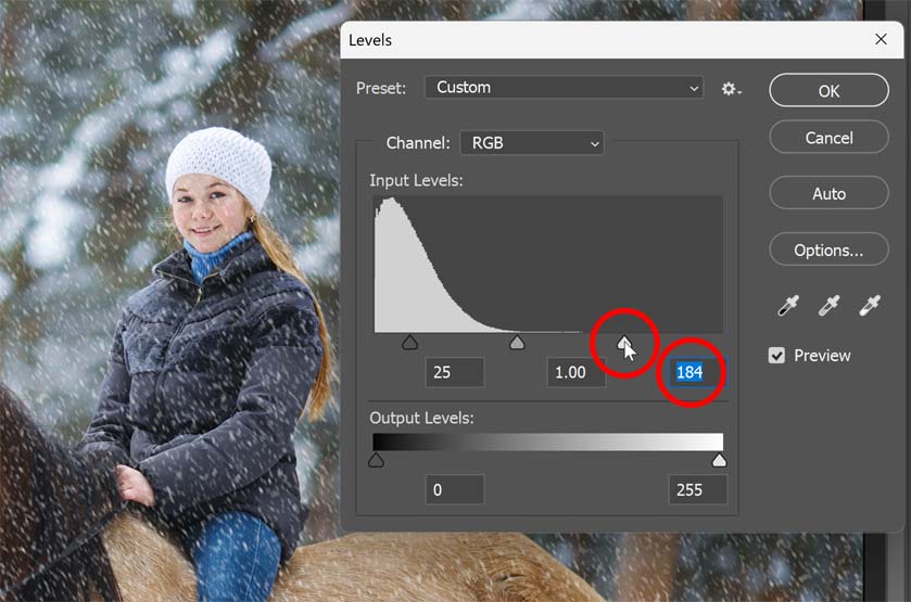 Dragging the white point slider to the left.